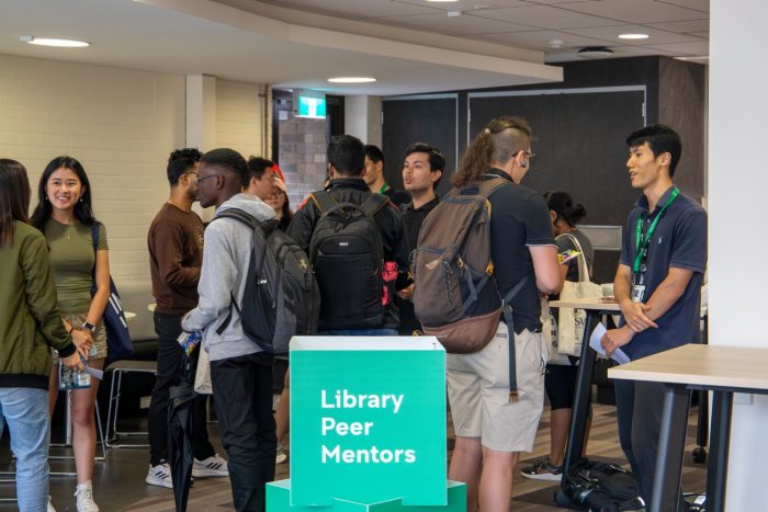  Library Peer Mentors and students chatting at a 'meet and greet' social event.