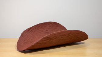 Piti. Oval shaped object with curved sides made from red clay. 'The Lawyers of the Uluru Statement' text overlay.