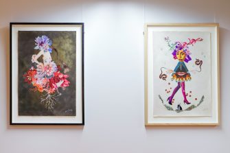 Installation view of two framed artworks. The work on the left is an abstract collage, featuring a female torso with flowers on a black background. The work on the right is a collage featuring a female face, legs, lips, and hands on a white background.