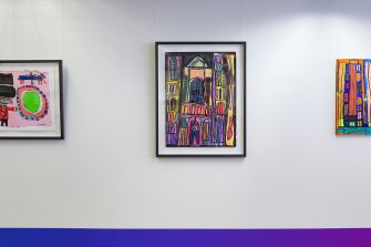 Installation view of three framed prints hung side-by-side. All three artworks have vibrant colours, displaying abstract images of people, animals, objects, and buildings.