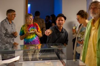 Photo of people socialising at the exhibition opening event. 