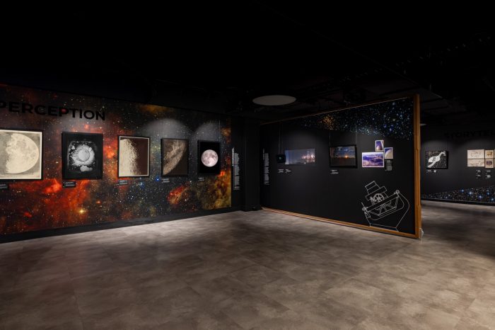 Exhibition gallery titled "Perception" featuring framed moon images on nebula background wall.