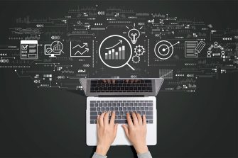 Subject guides - Literature reviews A bird's eye view of a pair of hands typing on a laptop. Various graphs, icons and symbols are coming out of the laptop as a cloud.