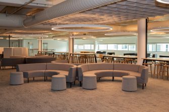 Academy Library space with semi-circular lounges, tall group study desks and individual seats.