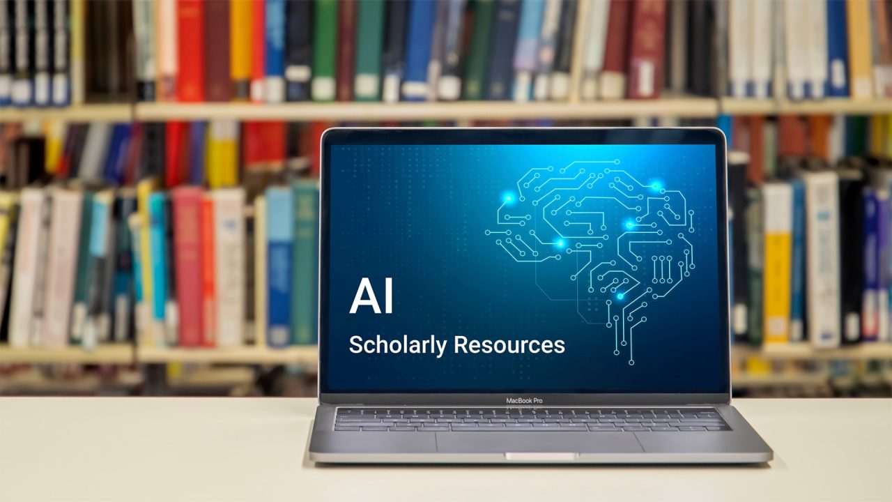 An open laptop with a blue image on its screen that reads: AI Scholarly Resources