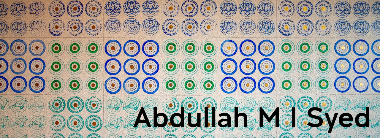 Detail of a mural on a white wall, featuring a repeating pattern of circles in blue and green ink, with gilded gold dots at the centre of the circles.