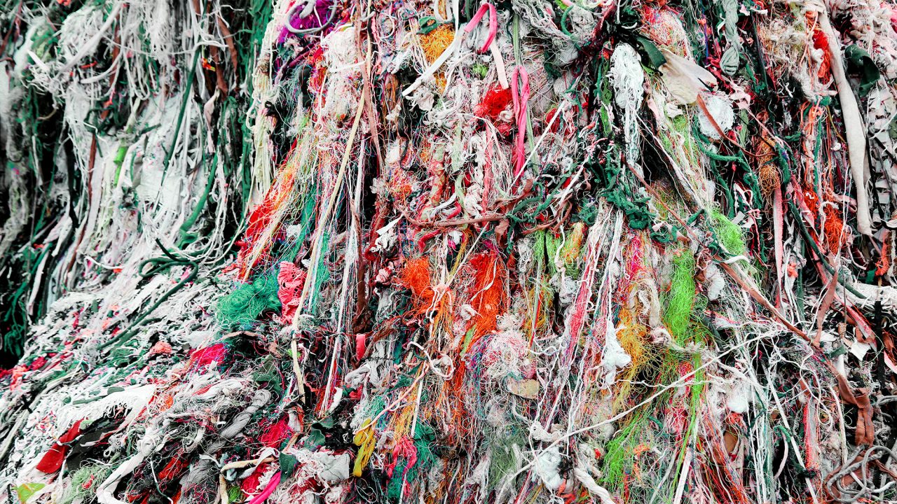 A large pile of colourful discarded textiles 