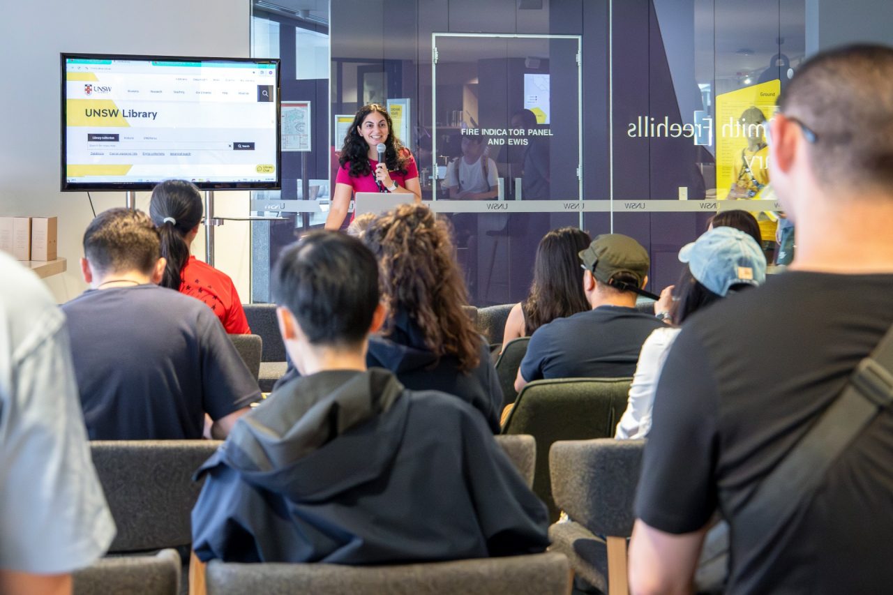 A librarian presenting in front of students inside the Law Library.