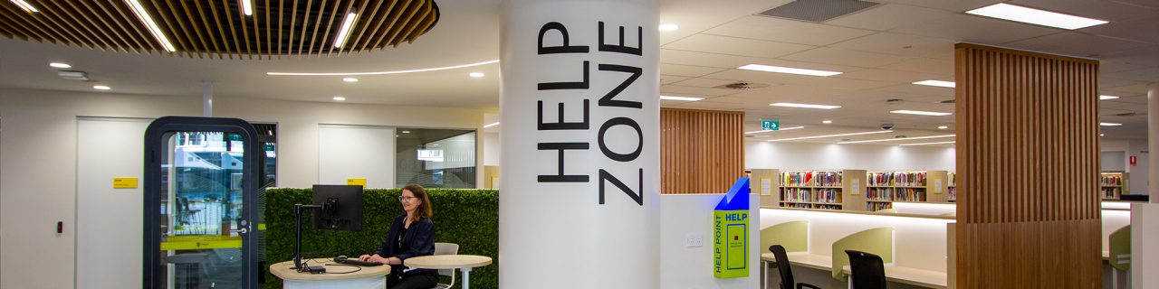Help Zone with staff sitting at desk and study areas behind